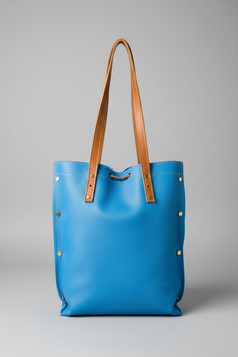 Sac fourre-tout artisanal en cuir de veau bleu avec liens de serrage en cuir camel et anses en cuir marron, fabriqué à la main en France par MOOAKUIR
